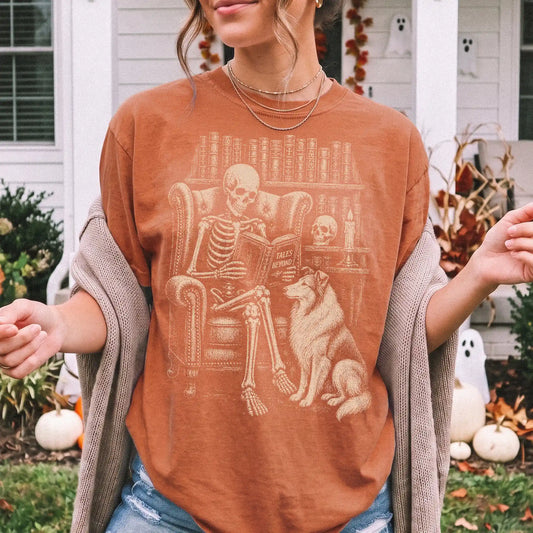 Model wearing a Yam Comfort Colors® T-shirt showing skeleton reading in a library beside a Collie