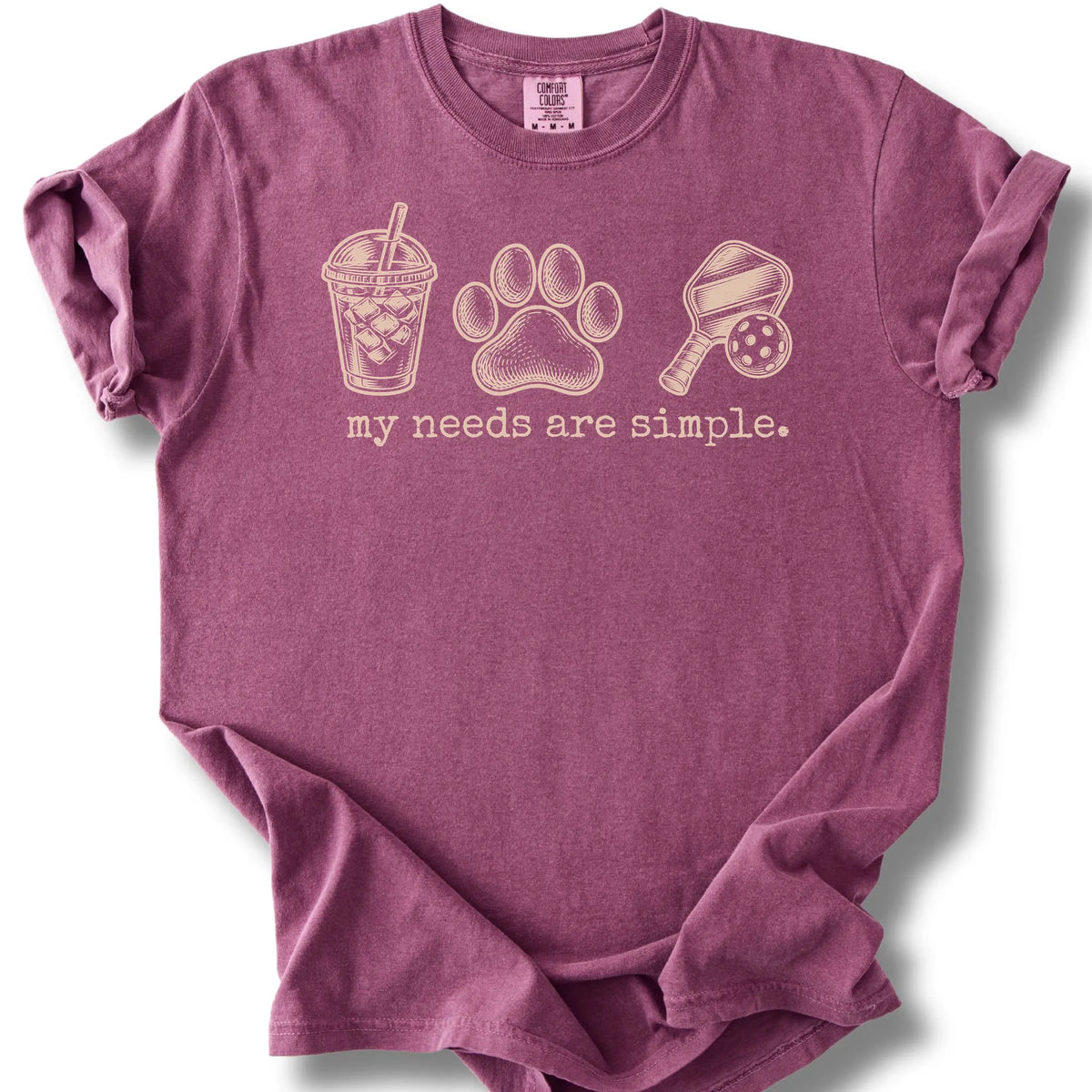 Iced coffee, a paw print and a paddle and ball on a berry T-shirt.