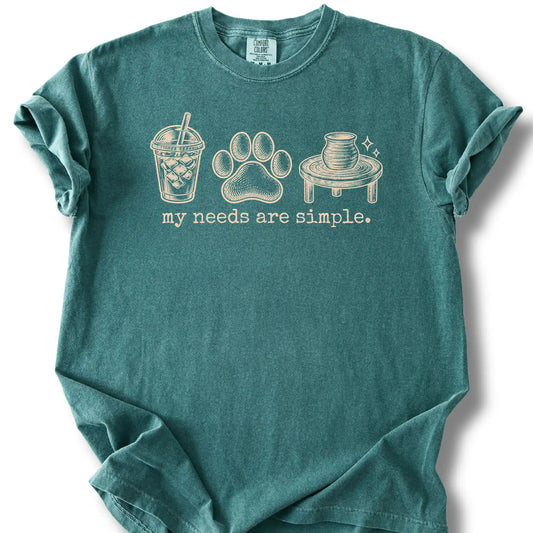 Iced coffee, a paw print and a pottery wheel on a blue spruce T-shirt.