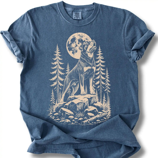 Rottweiler howling beneath the moon on a denim T-shirt.