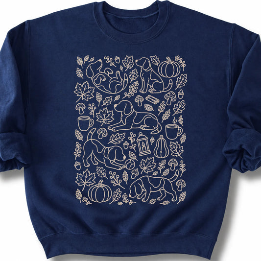 Beagle among autumn leaves and seasonal icons on a navy sweatshirt.