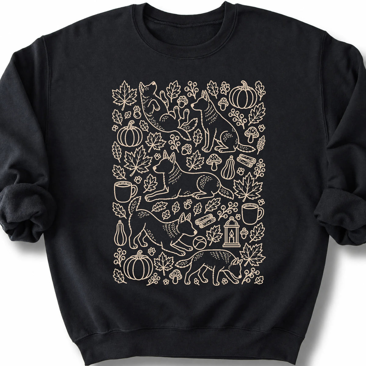 Blue Heeler among autumn leaves and seasonal icons on a black sweatshirt.