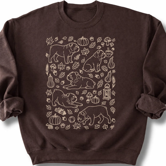 Bulldog among autumn leaves and seasonal icons on a dark chocolate sweatshirt.