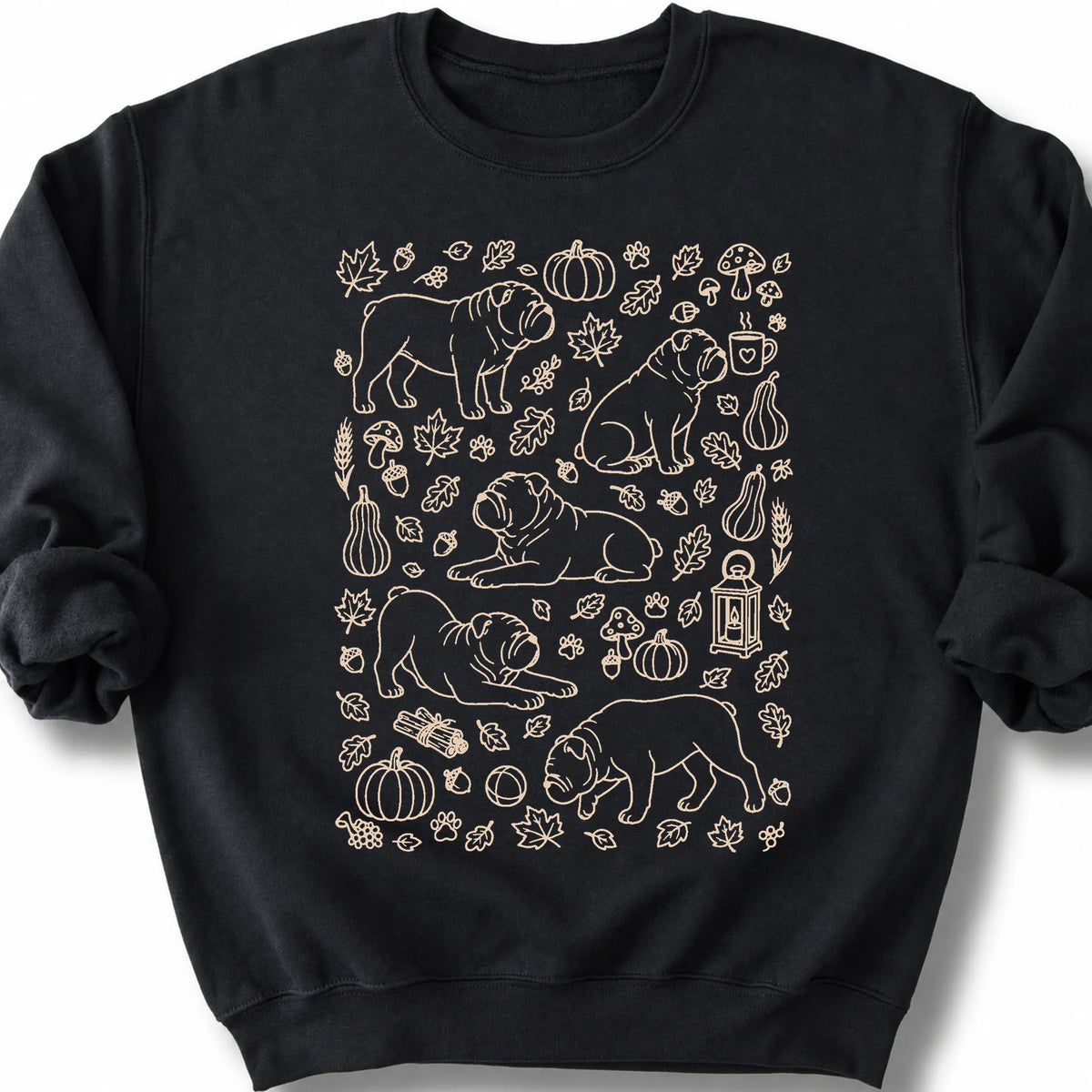 Bulldog among autumn leaves and seasonal icons on a black sweatshirt.