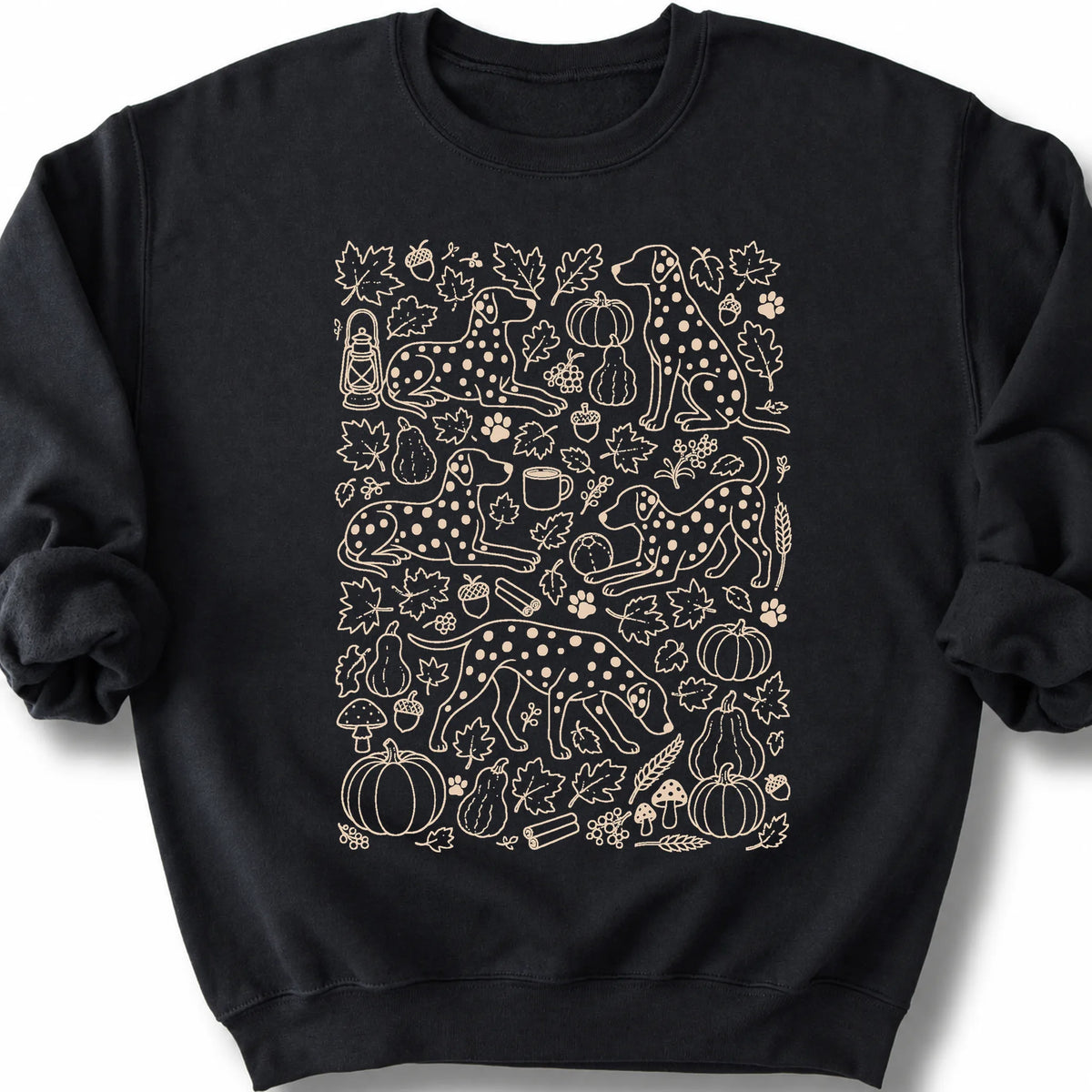 Dalmatian among autumn leaves and seasonal icons on a black sweatshirt.
