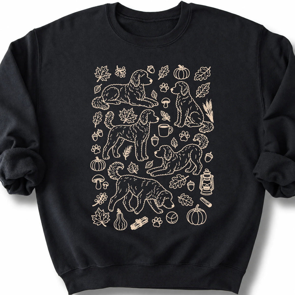 Goldendoodle among autumn leaves and seasonal icons on a black sweatshirt.