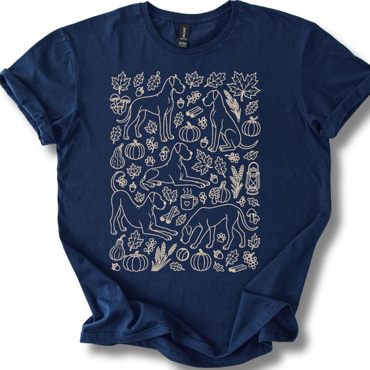 Great Dane among autumn leaves and seasonal icons on a navy T-shirt.