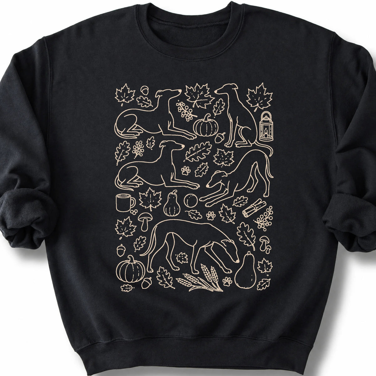 Greyhound among autumn leaves and seasonal icons on a black sweatshirt.