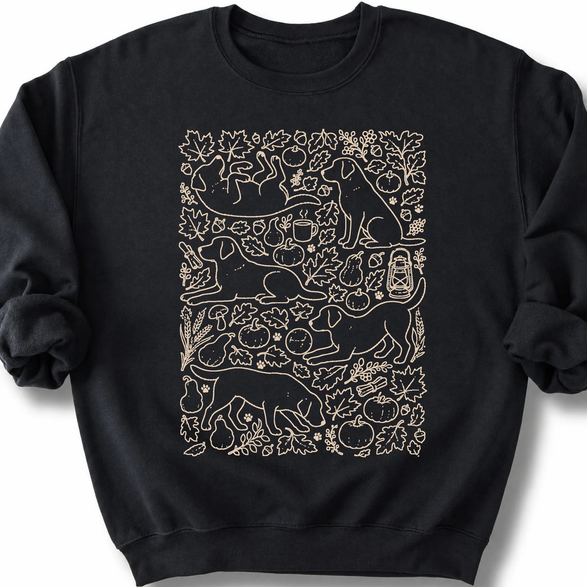 Labrador Retriever among autumn leaves and seasonal icons on a black sweatshirt.