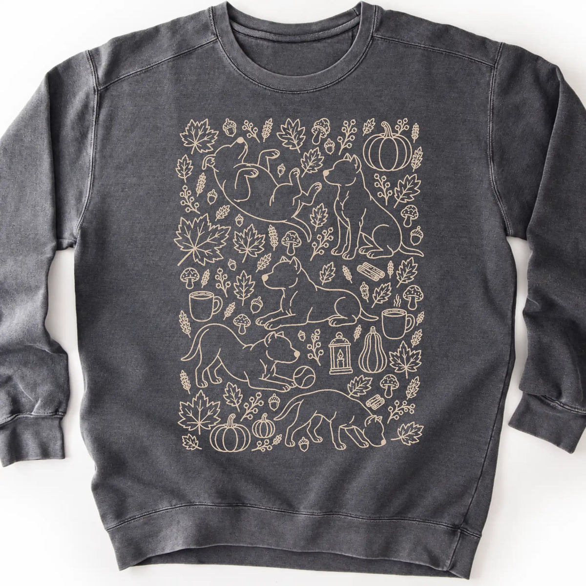 Pitbull among autumn leaves and seasonal icons on a pepper sweatshirt.