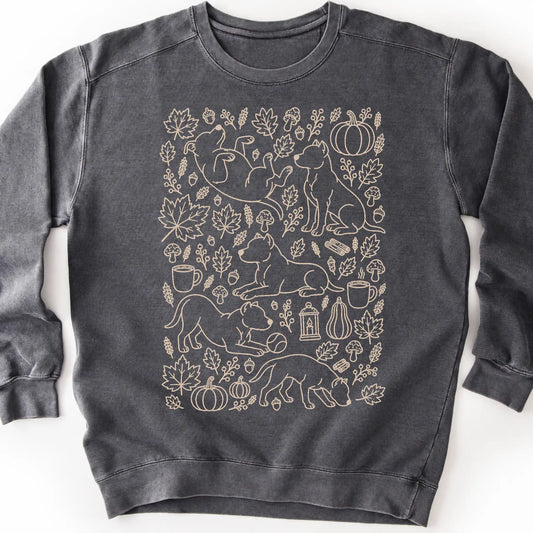 Pitbull among autumn leaves and seasonal icons on a pepper sweatshirt.