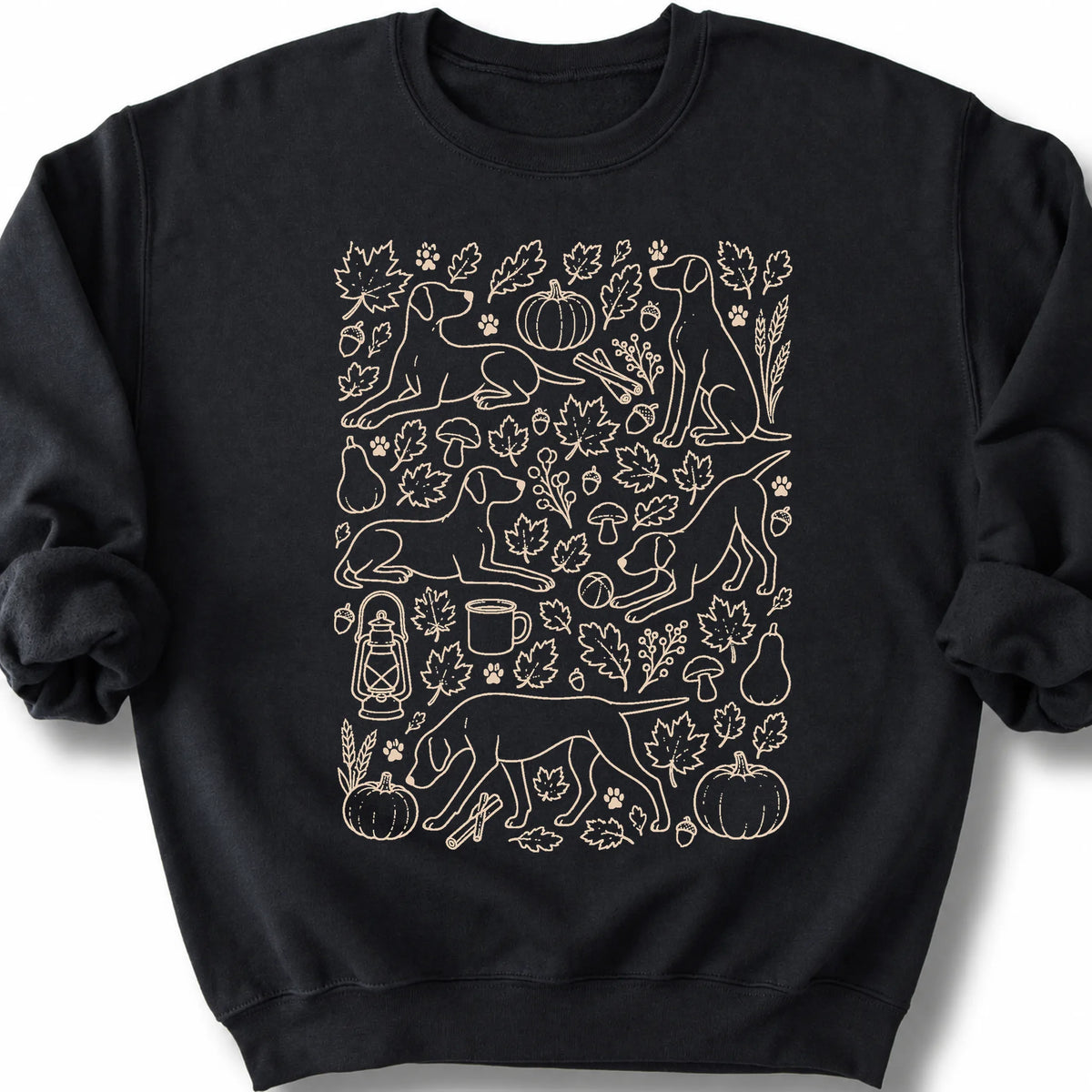 Pointer among autumn leaves and seasonal icons on a black sweatshirt.