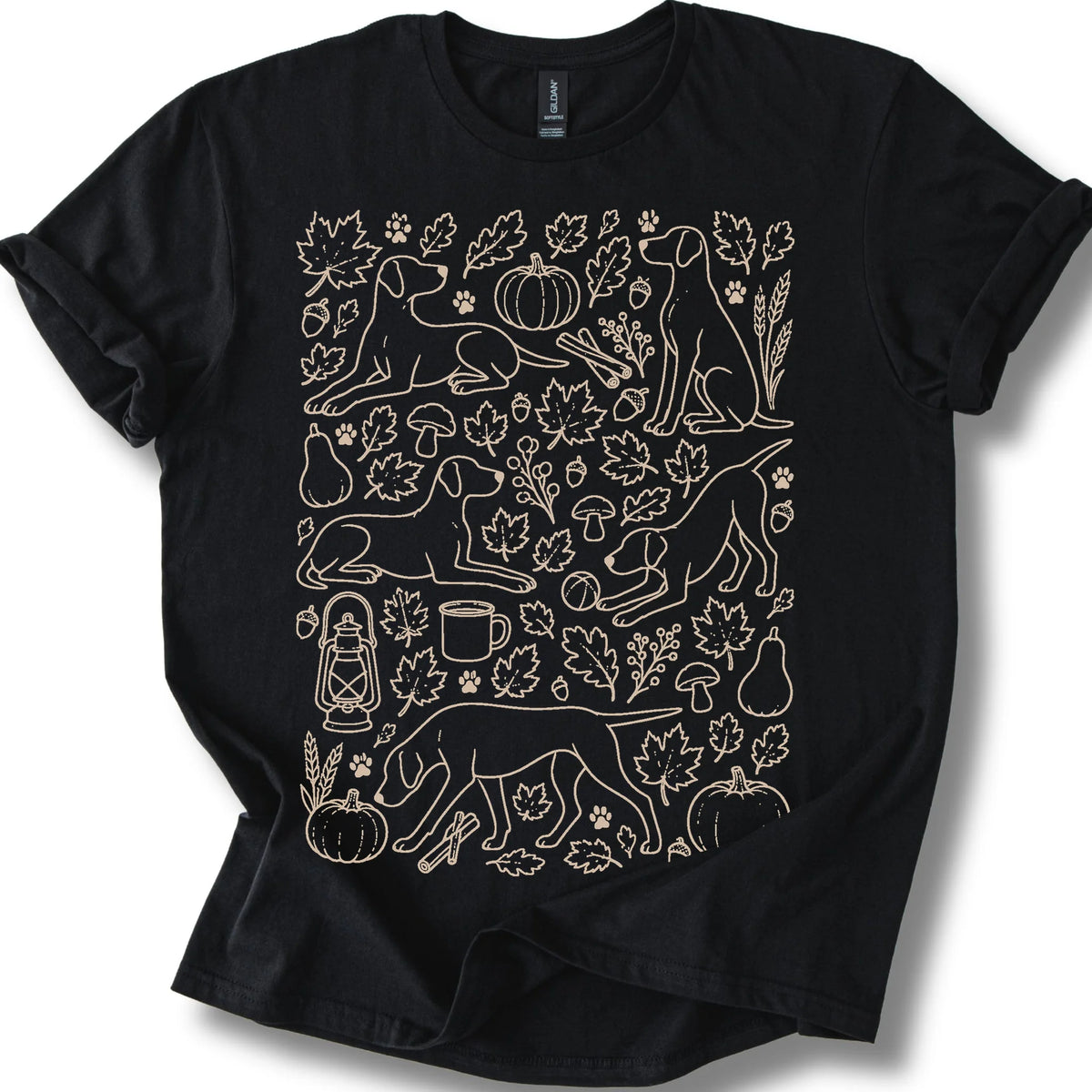 Pointer among autumn leaves and seasonal icons on a black T-shirt.