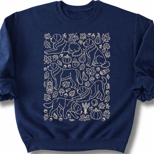 Saint Bernard among autumn leaves and seasonal icons on a navy sweatshirt.