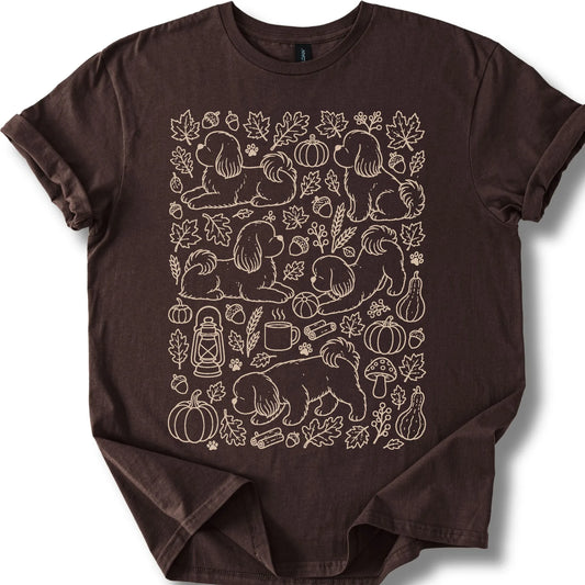 Shih Tzu among autumn leaves and seasonal icons on a dark chocolate T-shirt.
