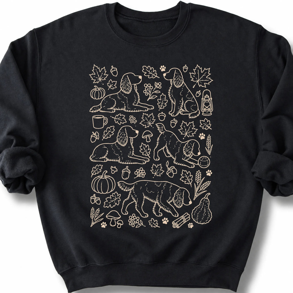 Springer Spaniel among autumn leaves and seasonal icons on a black sweatshirt.