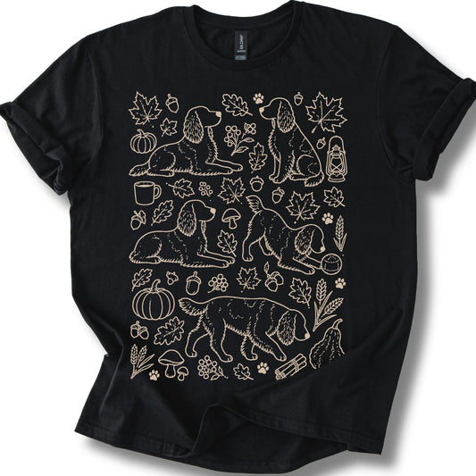 Springer Spaniel among autumn leaves and seasonal icons on a black T-shirt.
