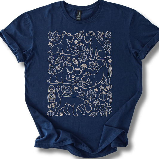 Standard Schnauzer among autumn leaves and seasonal icons on a navy T-shirt.