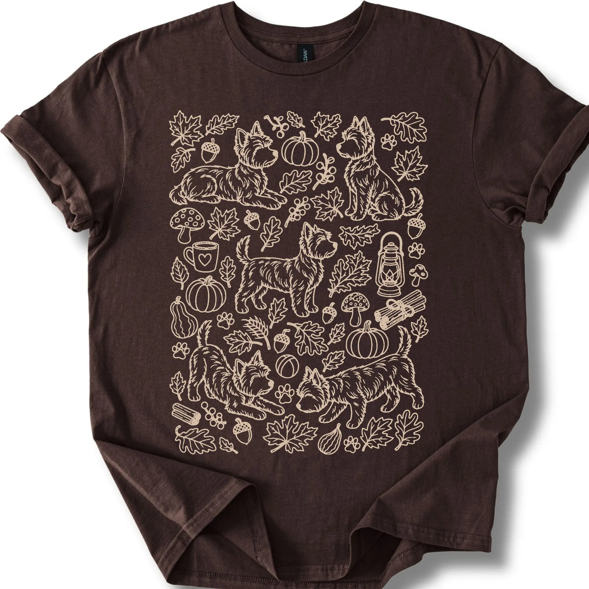 Yorkie among autumn leaves and seasonal icons on a dark chocolate T-shirt.