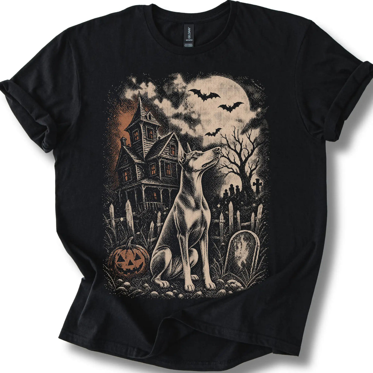 Doberman beside a haunted house on a black T-shirt.