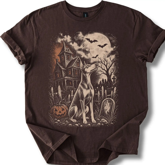 Doberman beside a haunted house on a dark chocolate T-shirt.