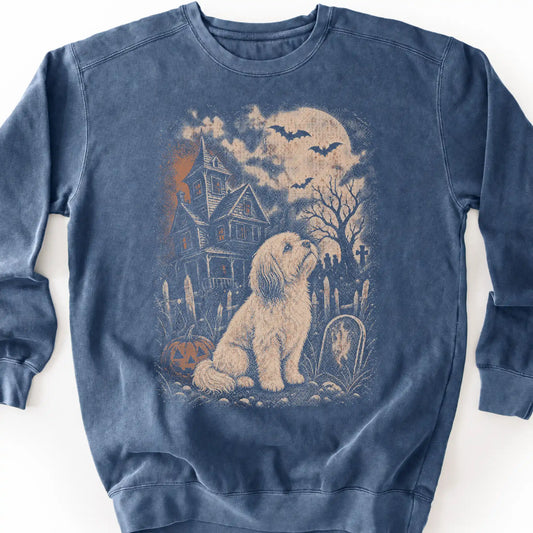 Havanese beside a haunted house on a denim sweatshirt.