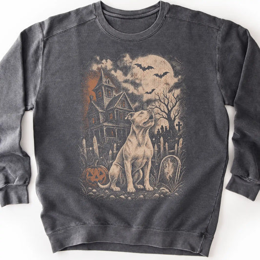 Pitbull beside a haunted house on a pepper sweatshirt.