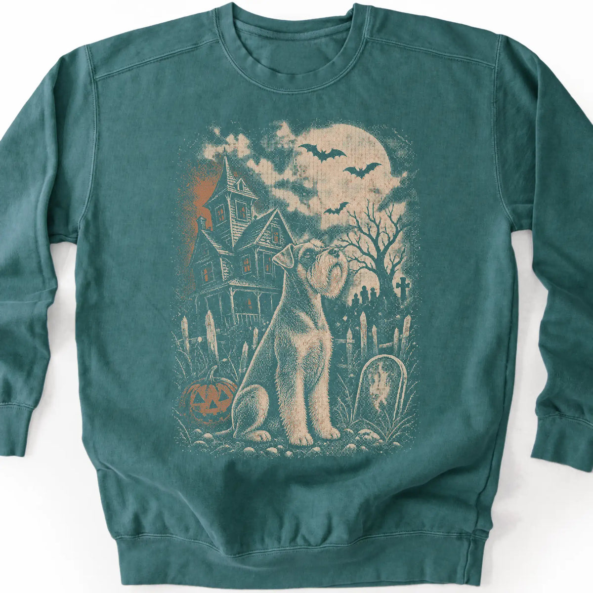 Schnauzer beside a haunted house on a blue spruce sweatshirt.