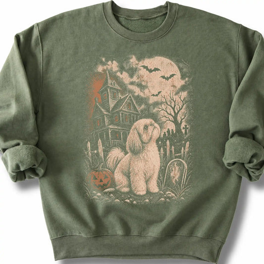 Shih Tzu beside a haunted house on a military green sweatshirt.
