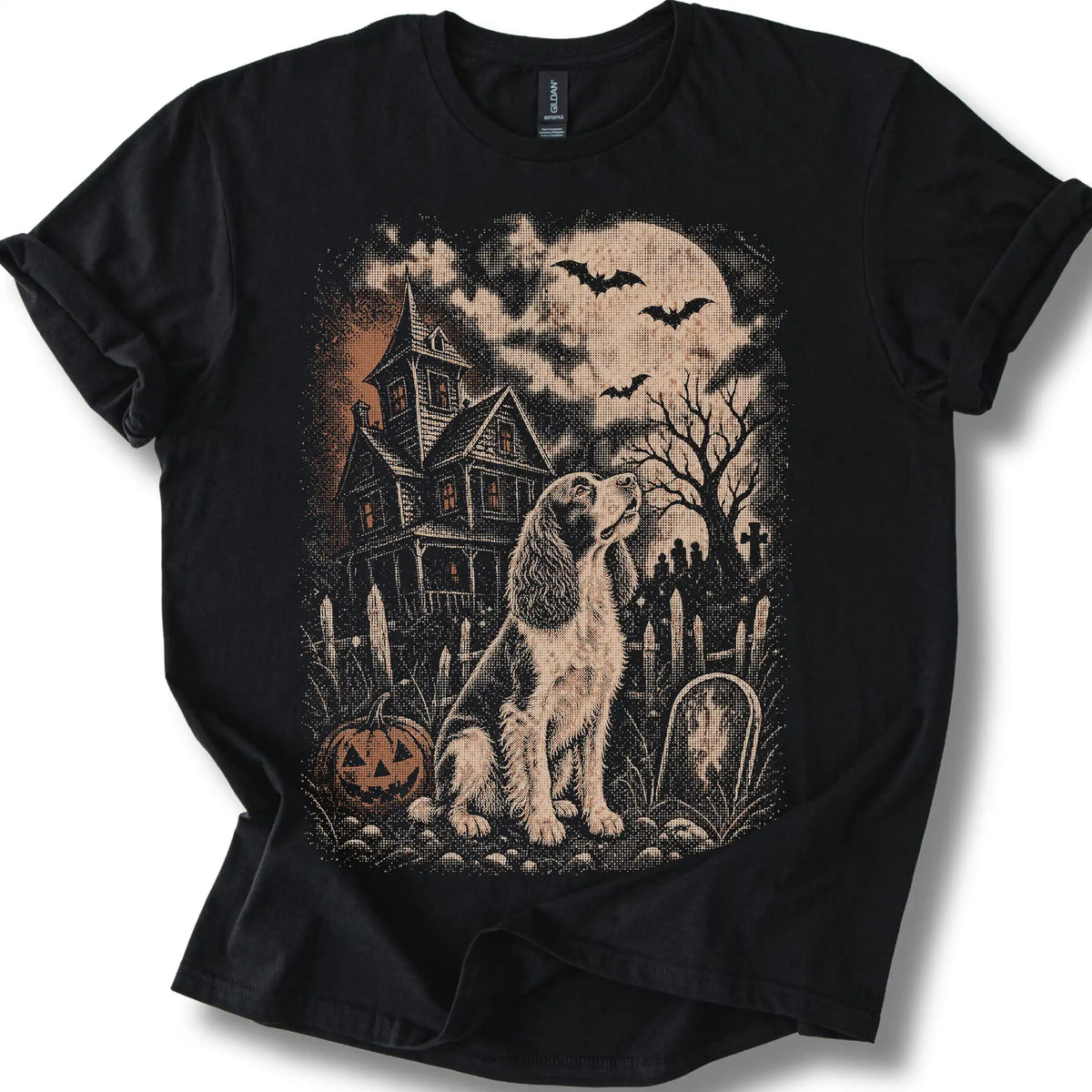 Springer Spaniel beside a haunted house on a black T-shirt.
