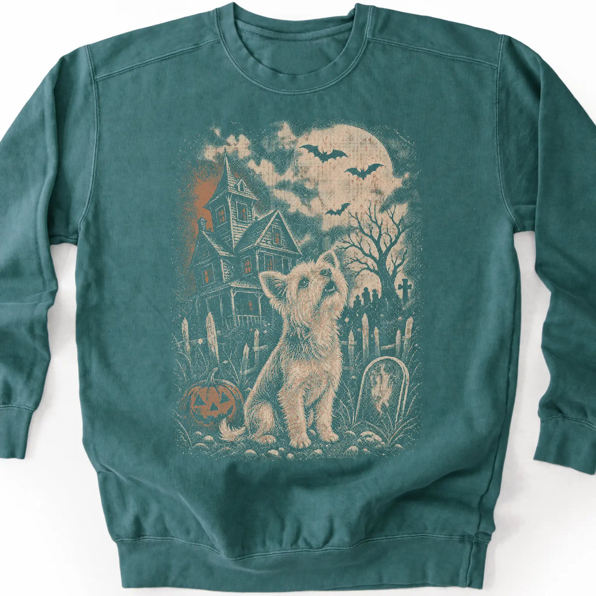Yorkie beside a haunted house on a blue spruce sweatshirt.
