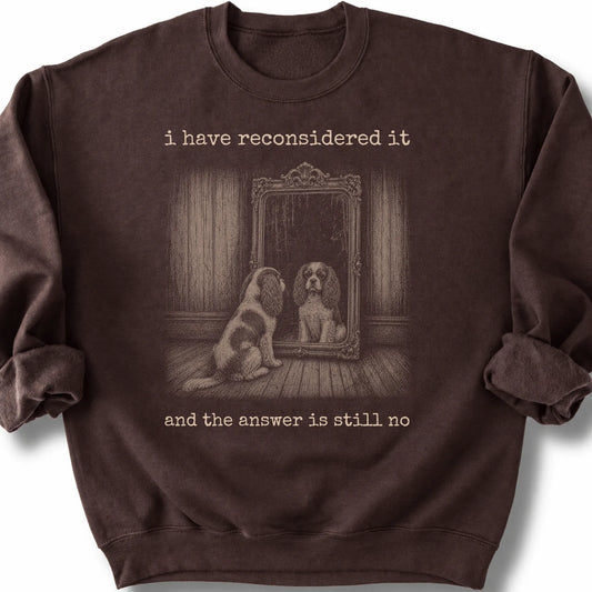 Cavalier King Charles Spaniel The Answer Is Still No on a Dark Chocolate crewneck sweatshirt, shown flat