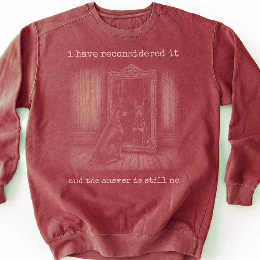 Doberman The Answer Is Still No on a Crimson crewneck sweatshirt, shown flat